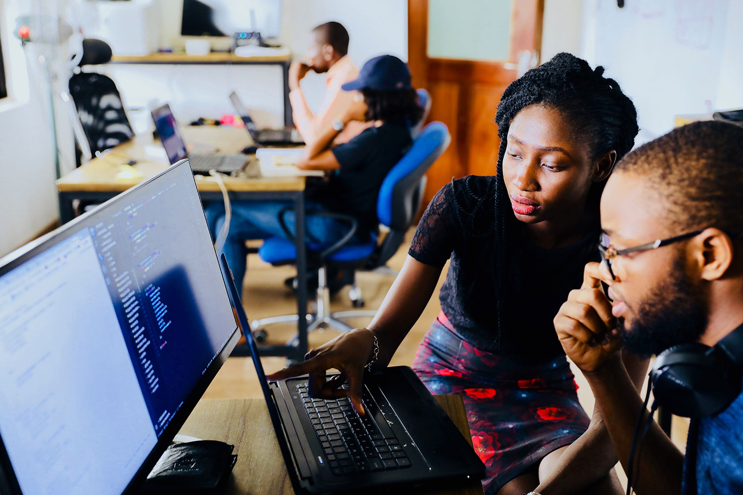 Image of two digital marketing professionals reviewing data quality reports on a computer.