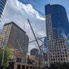 Photo taken in downtown Denver of a sculpture entitled "Soft Landing" with high rise buildings in the background.