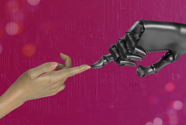 Machine and Human hand touching fingertips indicating a complementary relationship between AI and digital marketing professionals